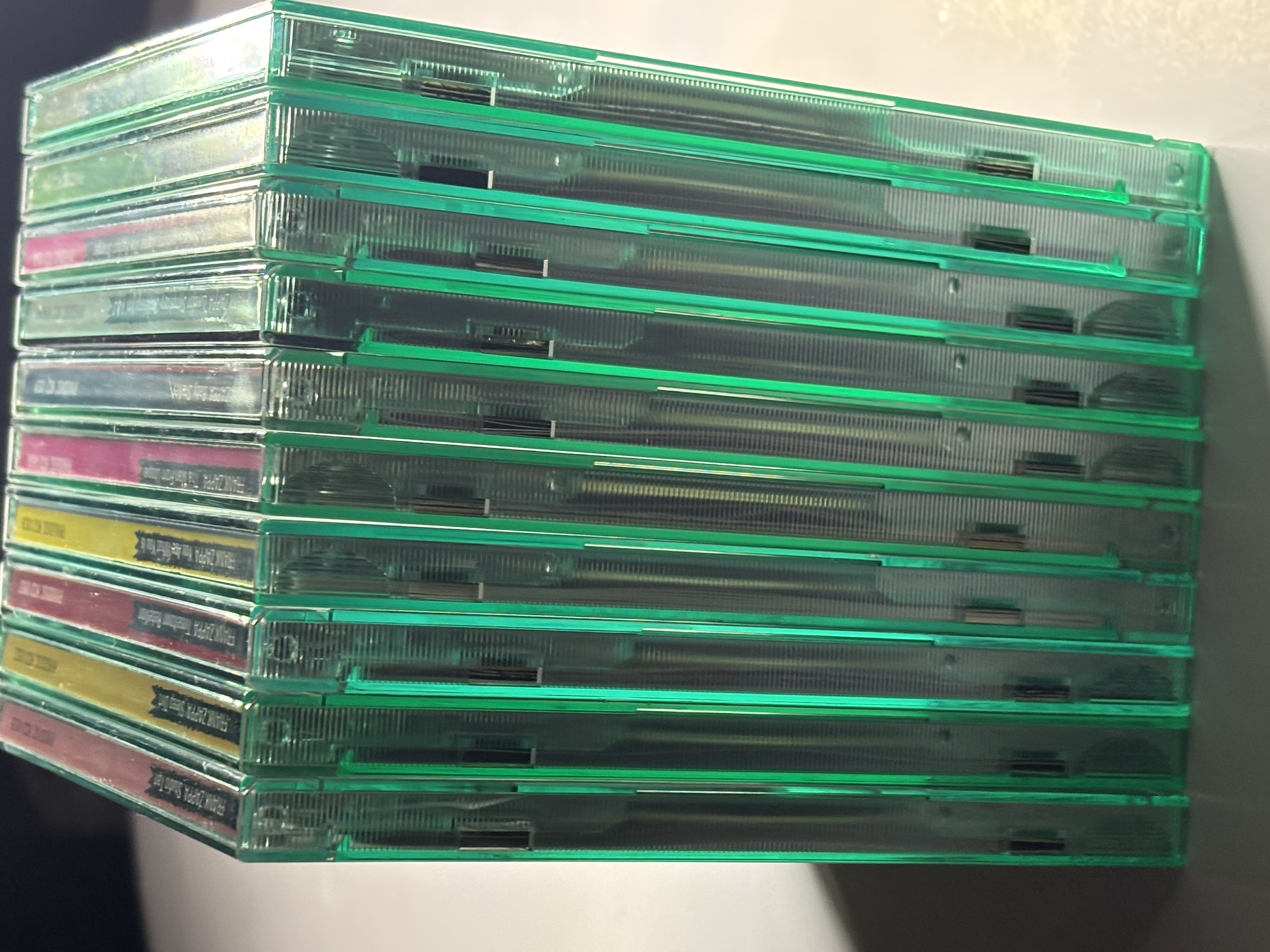Stack of backlit green Ryko case CDs